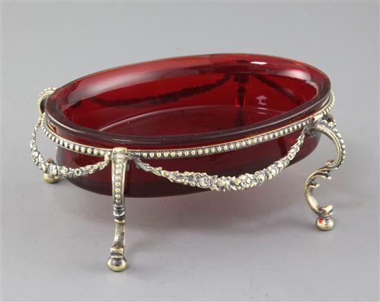 A 19th century continental silver gilt oval stand with ruby glass bowl, 18.5cm.